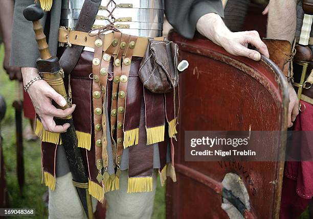 Actors dressed as Roman soldiers hold their swords during a commemoration of the Battle of Teutoburg Forest at the Kalkriese Museum and Park on May...
