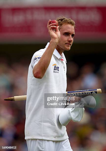 Stuart Broad of England raises the match ball to acknowledge the crowd as he leaves the field as England win the 1st Investec Test match between...