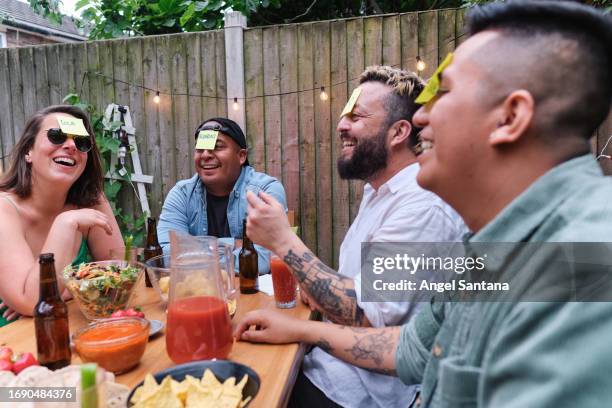 diversity of friends enjoying an afternoon of games - four people stock pictures, royalty-free photos & images