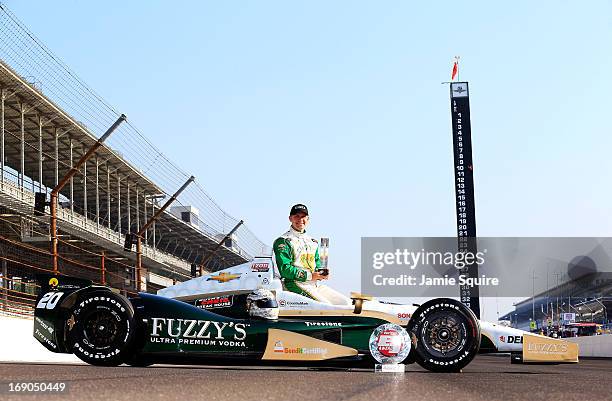 Ed Carpenter, driver of the Fuzzy's Vodka/Ed Carpenter Racing Chevrolet, poses on the track after qulaifying on the pole for the 2013 Indianapolis...