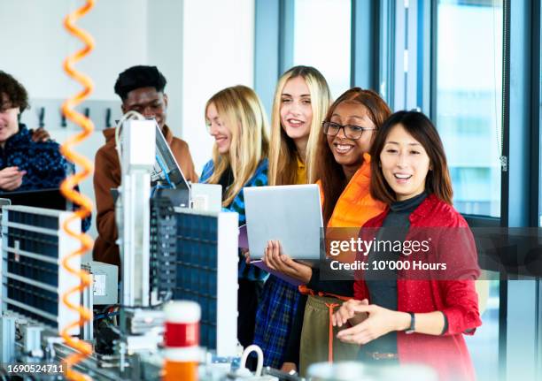 group of engineering students using laptop to operate production line - industrial plant stock pictures, royalty-free photos & images