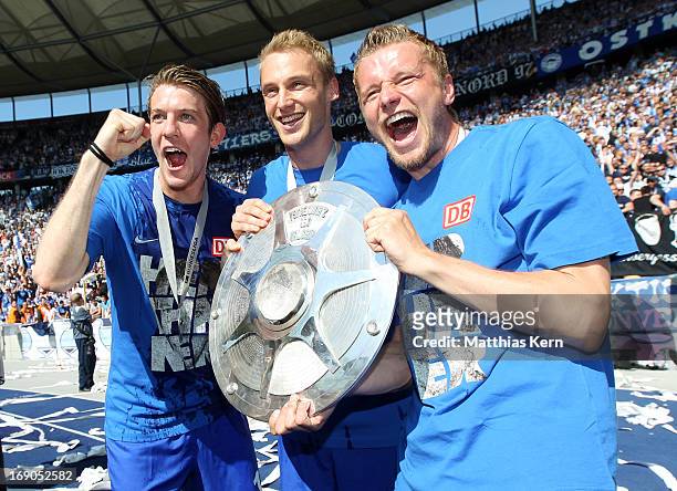 Peter Niemeyer, Felix Bastians and Maik Franz of Berlin pose with the cup after winning the championship after the Second Bundesliga match between...