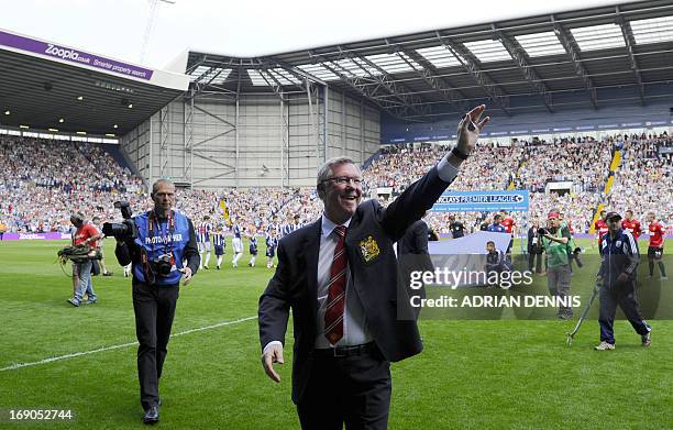 Manchester United manager Alex Ferguson acknowledges the crowd before the start of the English Premier League football match between West Bromwich...
