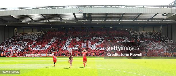 Jamie Carragher of Liverpool claps to the fans in the Kop before the Barclays Premier League match between Liverpool and Queens Park Rangers at...