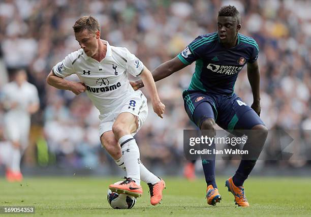 Alfred N'Diaye of Sunderland tries to tackle Scott Parker of Tottenham Hotspur during the Barclays Premier League match between Tottenham Hotspur and...