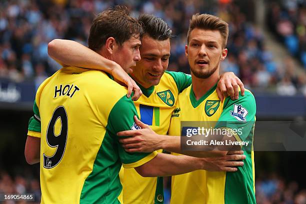 Grant Holt of Norwich City celebrates with team mates after scoring during the Barclays Premier League match between Manchester City and Norwich City...