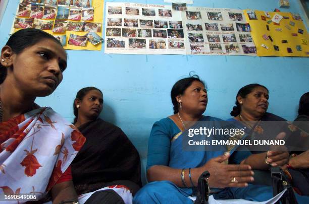 Indian sex workers attend a Swati Mahila Sangha meeting, a sex worker group which promotes condom use as part of an AIDS-prevention initiative funded...