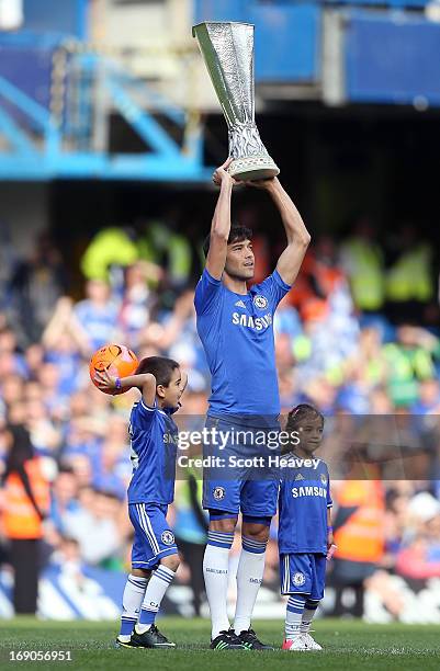 Paulo Ferreira of Chelsea holds aloft the UEFA Europa League trophy as he celebrates on the pitch after the Barclays Premier League match between...