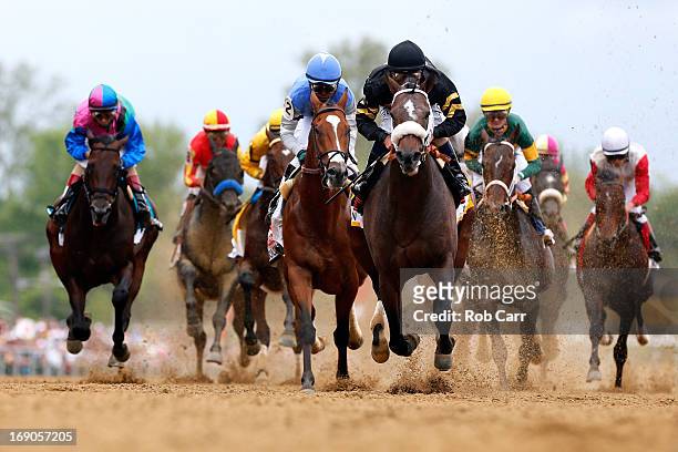 Oxbow, ridden by Gary Stevens, leads the field at the start of the race to win the 138th running of the Preakness Stakes at Pimlico Race Course on...