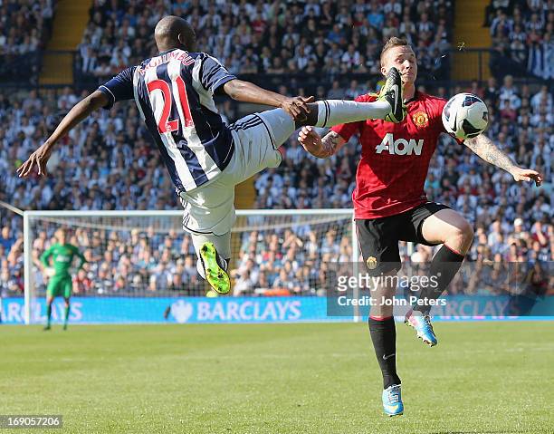 Alexander Buttner of Manchester United in action with Yossouf Mulumbu of West Bromwich Albion during the Barclays Premier League match between Wet...
