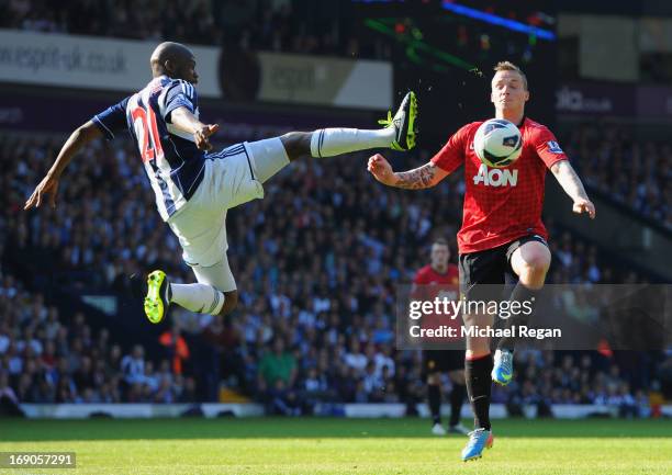 Youssuf Mulumbu of West Bromwich Albion battles with Alexander Buttner of Manchester United during the Barclays Premier League match between West...