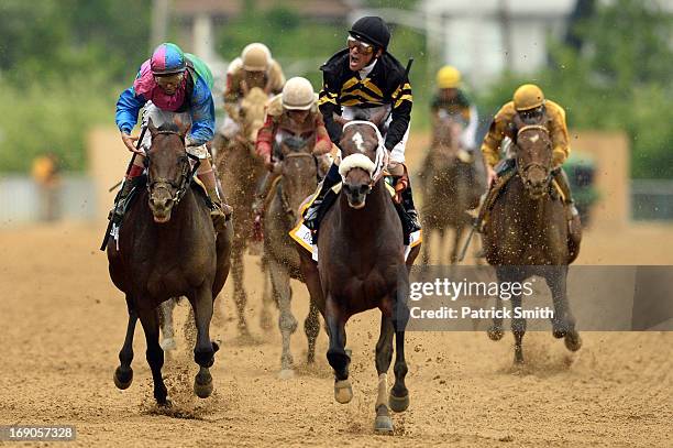 Gary Stevens celebrates atop of Oxbow as he comes to the finish line to win the 138th running of the Preakness Stakes at Pimlico Race Course on May...