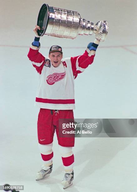 Sergei Fedorov from Russia and Center for the Detroit Red Wings holds aloft the Stanley Cup trophy after winning the 1997 NHL Stanley Cup Finals...