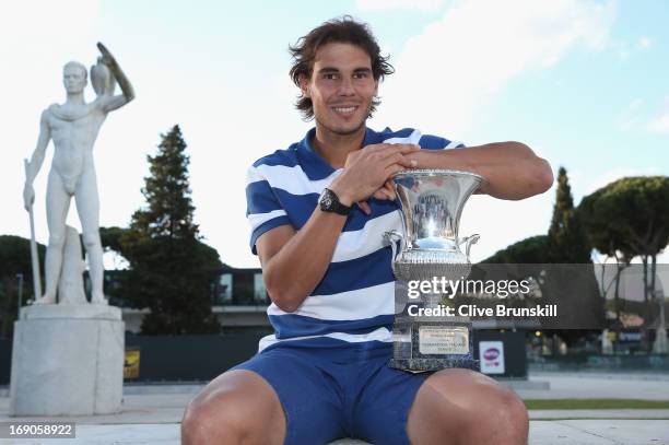 Rafael Nadal of Spain poses for a photo in front of the statues of Pietrangeli court after his straight sets victory against Roger Federer of...