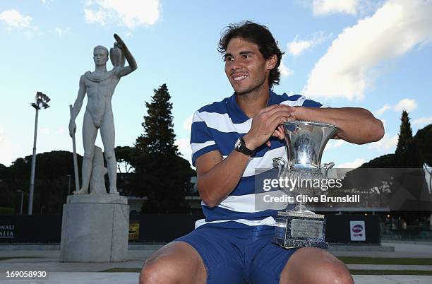 Rafael Nadal of Spain poses for a photo in front of the statues of Pietrangeli court after his straight sets victory against Roger Federer of...