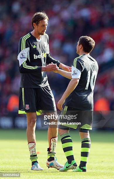 Michael Owen of Stoke City shakes hands with team mate Peter Crouch after the Barclays Premier League match between Southampton and Stoke City at St...