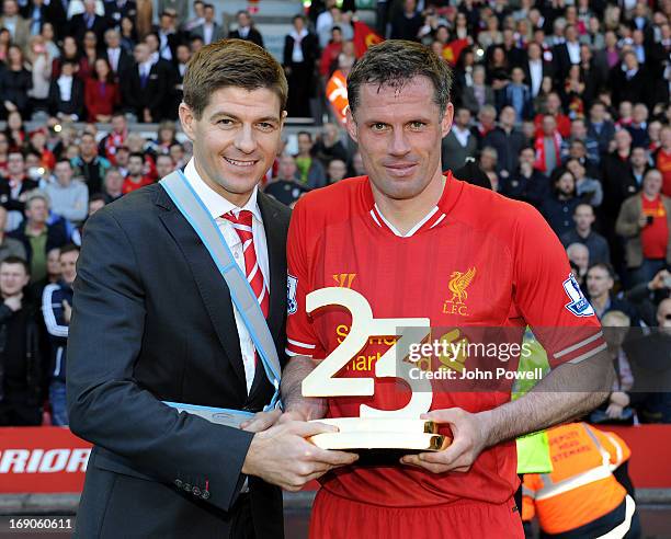 Steven Gerrard and Jamie Carragher of Liverpool hold the trophy awarded to Jamie Carragher after Carragher's last game, during the Barclays Premier...