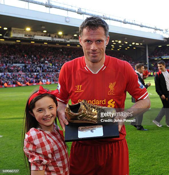 Jamie Carragher of Liverpool with his golden boot awarded by the fans at thew end of the Barclays Premier League match between Liverpool and Queens...