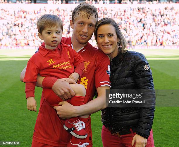 Lucas Leiva of Liverpool poses with his wife Ariana Lima and son Pedro at the end of the Barclays Premier League match between Liverpool and Queens...