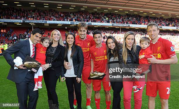 Luis Suarez, Sebastian Coates, Philippe Coutinho and Lucas Leiva of Liverpool pose with members of their families at the end of the Barclays Premier...