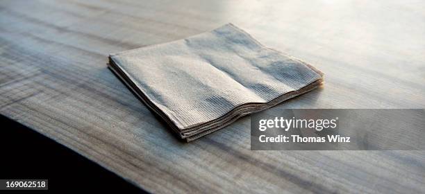 paper napkins on a wooden table - paper napkin fotografías e imágenes de stock