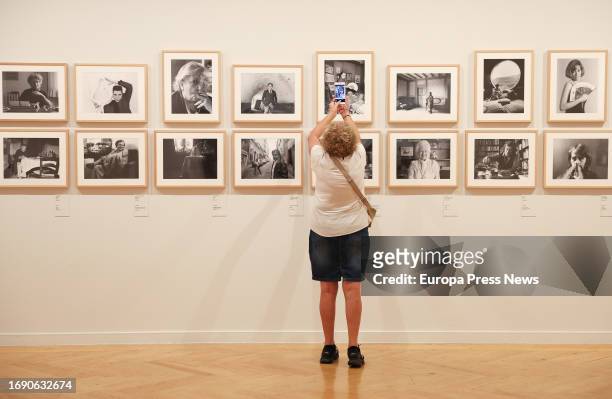 Woman photographs one of the works at the presentation of the exhibition 'Memoria vivida' by Pilar Aymerich, at the Circulo de Bellas Artes, on 19...