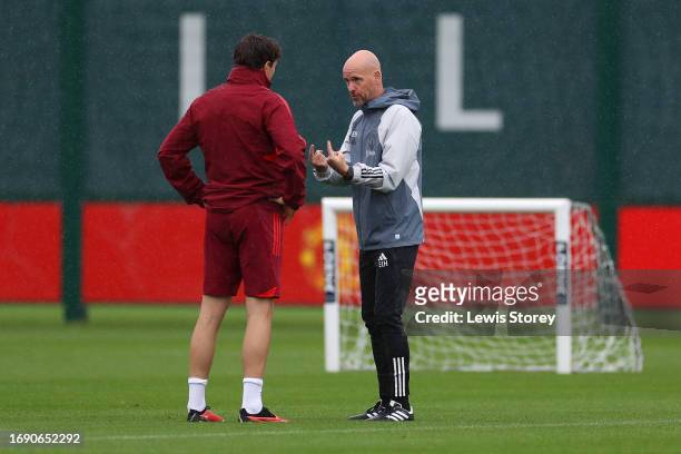 Erik ten Hag, Manager of Manchester United, speaks with Victor Lindeloef of Manchester United during a Manchester United Training Session at...