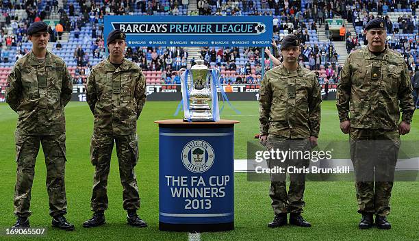 Members of the armed forces with the FA Cup prior to the Barclays Premier League match between Wigan Athletic and Aston Villa at DW Stadium on May...