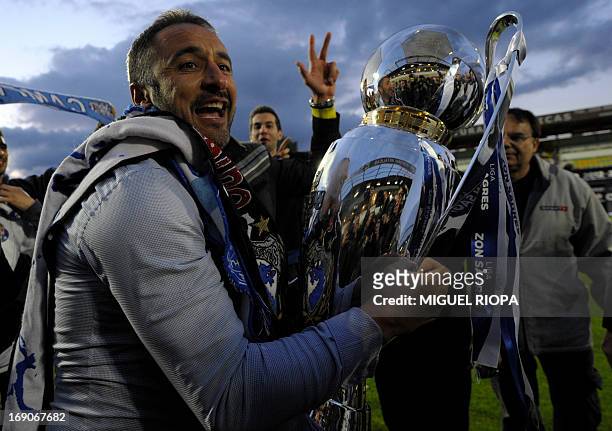 Porto's coach Vitor Pereira holds the trophy after winning the Portuguese league at the end of the football match against Pacos Ferreira at the Mata...