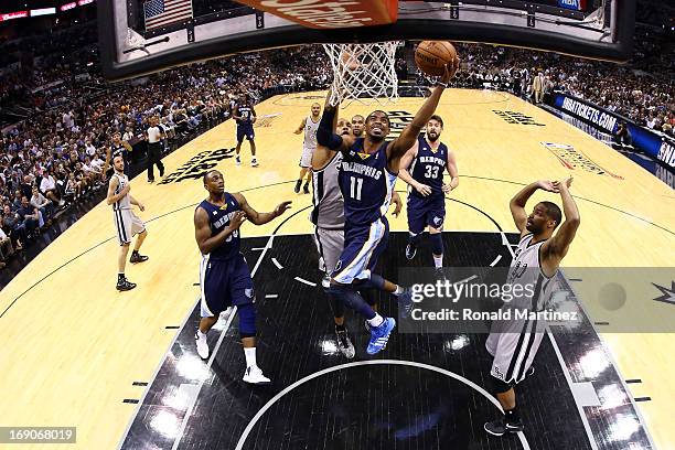 Mike Conley of the Memphis Grizzlies drives for a shot attempt against Boris Diaw of the San Antonio Spurs in the first half during Game One of the...