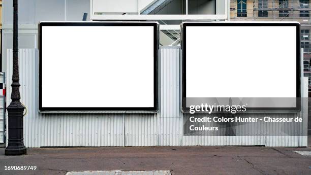 two empty white advertising panels on a white corrugated iron wall with an asphalt street and a retro-style street light in paris, france - reklam bildbanksfoton och bilder