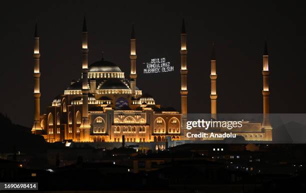 View of the illuminated message, known as 'mahya', hung between two minarets of the Grand Camlica Mosque during the celebrations for Mawlid al-Nabi,...