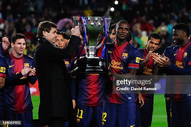 Head coach Tito Vilanova and Eric Abidal of FC Barcelona holds up the trophy during the celebration after winning the Spanish League after the La...