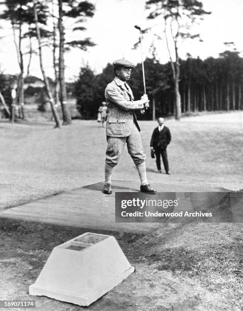 Prince Hirohito watches his ball after his drive at the Tokyo Golf Club, Tokyo, Japan, August 16, 1926.