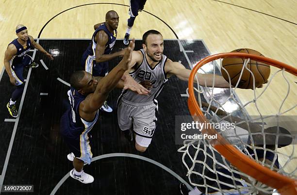 Manu Ginobili of the San Antonio Spurs drives for a shot attempt against Darrell Arthur of the Memphis Grizzlies during Game One of the Western...