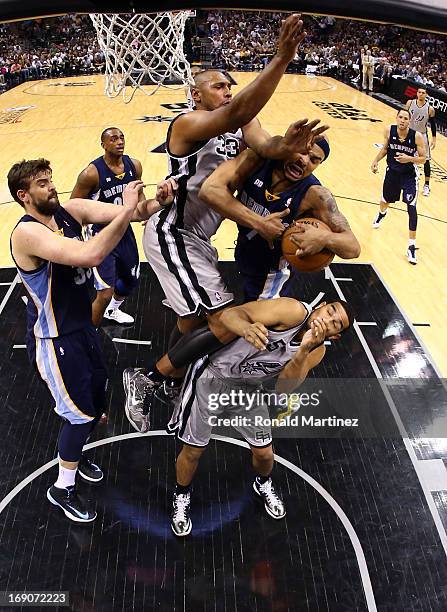 Jerryd Bayless of the Memphis Grizzlies draws contact as he drives to the basket in the second half against Boris Diaw and Cory Joseph of the San...