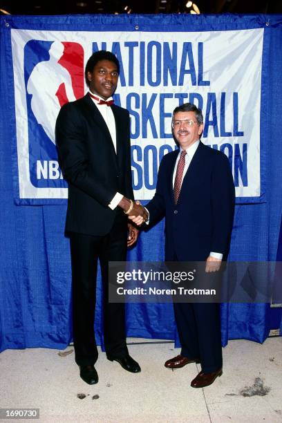Commissioner David Stern congratulates Akeem Olajuwon after being drafted first overall by the Houston Rockets during the 1984 NBA Draft. NOTE TO...