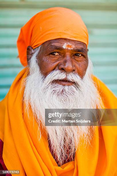 portrait of a sadhu holy man in yellow - túnica fotografías e imágenes de stock