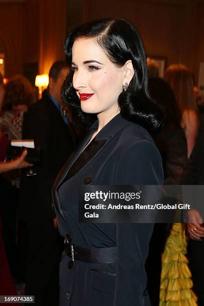Dita Von Teese attends the 'Global Gift Gala' 2013 cocktail presented by Eva Longoria at Carlton Hotel on May 19, 2013 in Cannes, France.