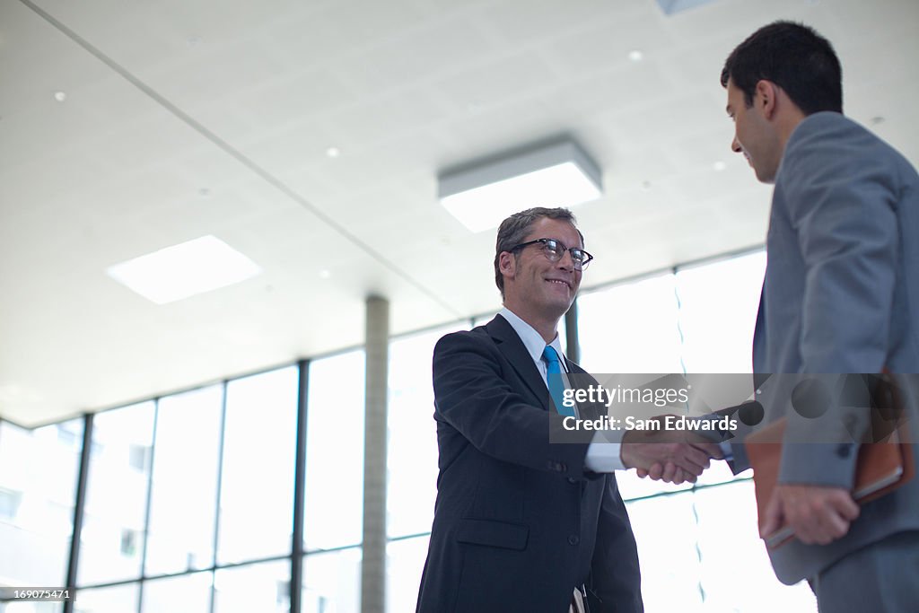 Businessmen shaking hands together