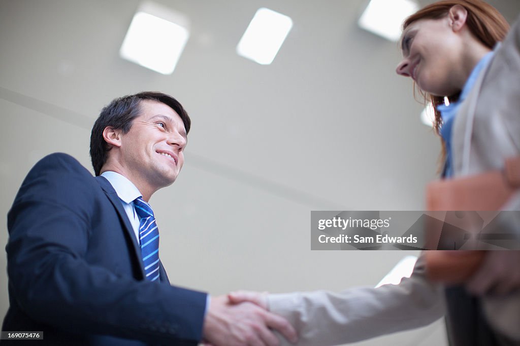 Business people shaking hands together