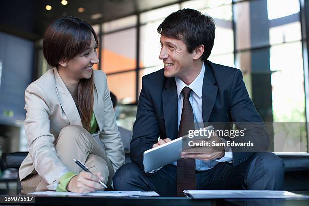 business people using digital tablet together - curiosity business stock pictures, royalty-free photos & images