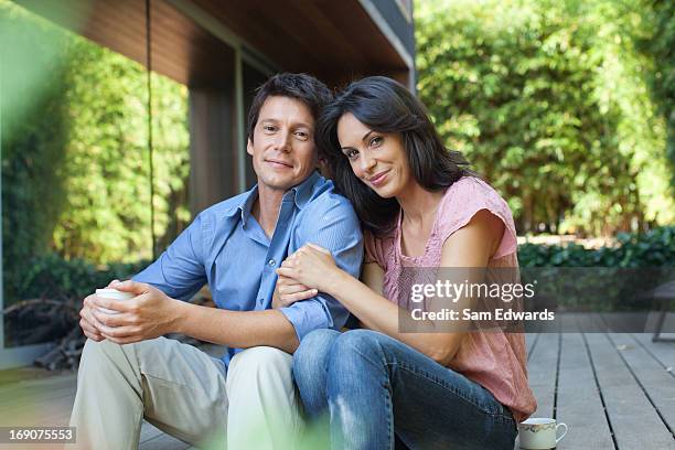 couple sitting together on patio - 30 39 years stock pictures, royalty-free photos & images