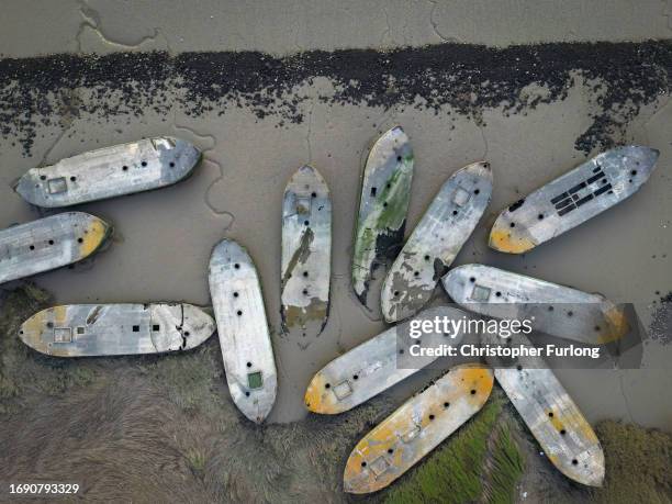 In this aerial view, WW2 concrete barges lay in the mud on the shoreline of the River Thames on September 11, 2023 in Rainham, United Kingdom. Near...