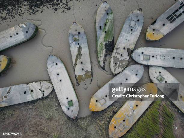 In this aerial view, WW2 concrete barges lay in the mud on the shoreline of the River Thames on September 11, 2023 in Rainham, United Kingdom. Near...