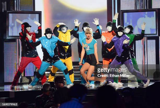 Singer Taylor Swift and members of the Jabbawockeez dance crew perform during the 2013 Billboard Music Awards at the MGM Grand Garden Arena on May...