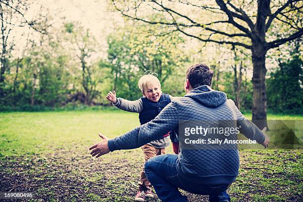 father and son hug - young man arms up bildbanksfoton och bilder