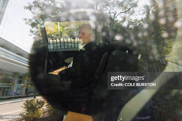 Seen through a police vehicle window, Canadian-Finnish fashion mogul Peter Nygard leaves a courthouse in Toronto, Ontario, on September 26, 2023....