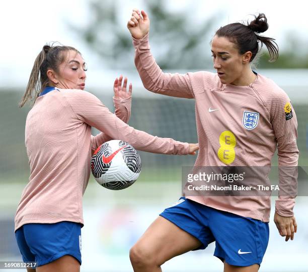 Lucy Bronze and Katie Zelem of England battle for possession during a training session at St George's Park on September 19, 2023 in Burton upon...