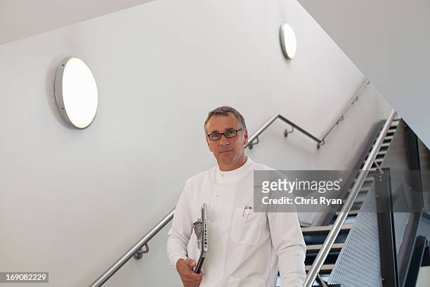 scientist on stairway - clipboard and glasses stock pictures, royalty-free photos & images
